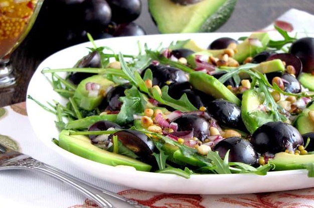 Salad with avocado and black grapes