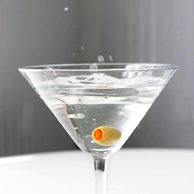 In a martini cocktail lay the olive